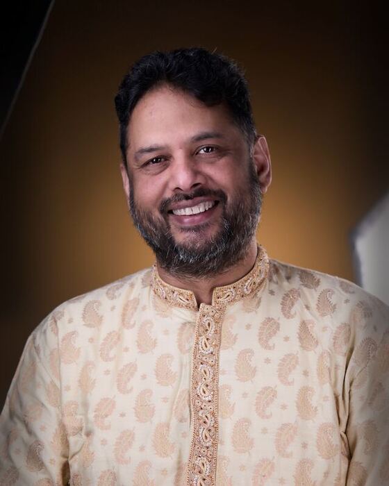Smiling in a cream embroidered kurta