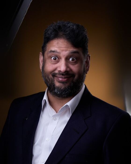 Wide-eyed comic expression in a suit